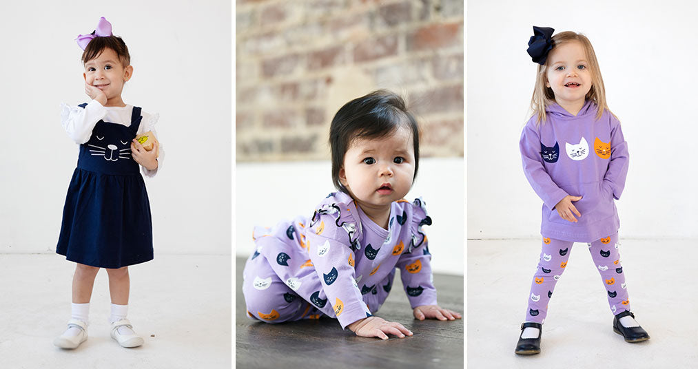 Three children wearing garments from our Curious Cats line in purple and navy
