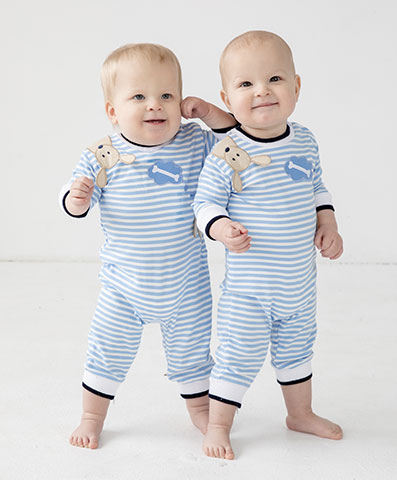 twin toddler boys in matching blue and white stripe longalls