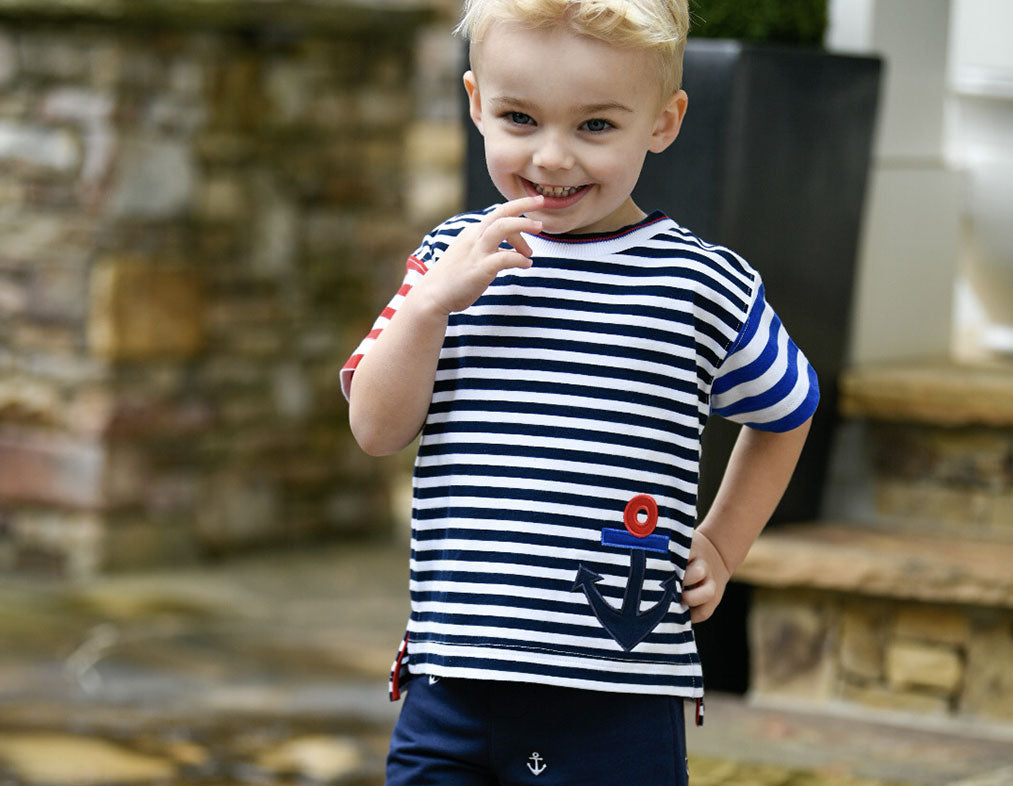 young boy in striped anchor shirt and matching shorts
