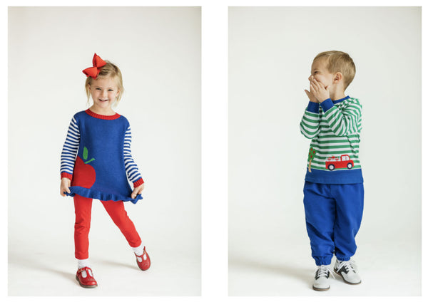 a girl in a blue tunic with apple and red pants and a boy in a green and white stripe sweater and blue pants