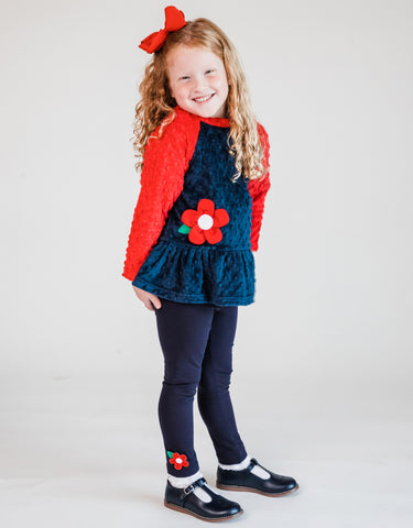 girl wearing a fleece top with flower and matching leggings