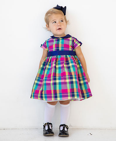 young girl in pink, green and blue plaid taffeta dress