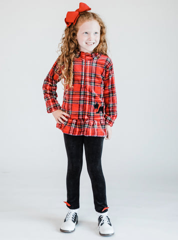 young girl wearing a plaid yorkie fleece top and leggings