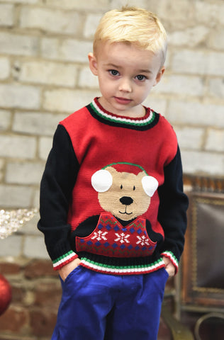 young boy in red bear sweater and blue pants