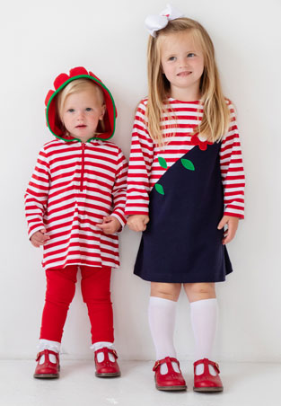 sisters wearing red and stripe knit outfits
