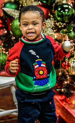 boy in train sweater with bauble